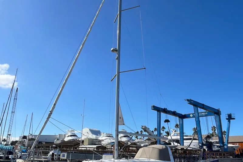La Bella Vita Yacht Photos Pics 2015 Beneteau Oceanis 45 sailboat docked at a marina under clear blue skies.