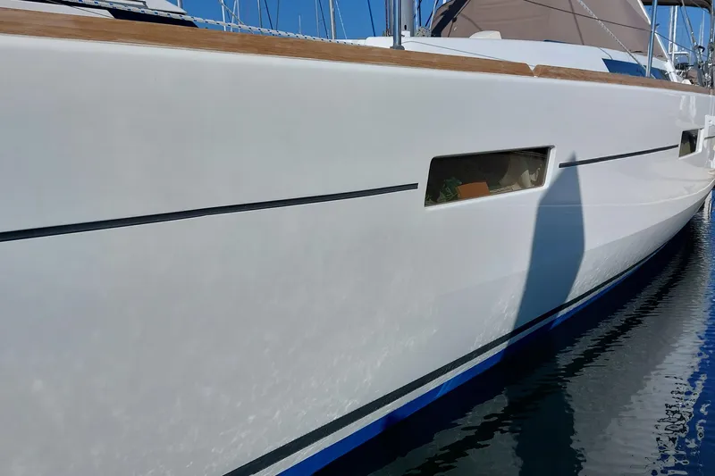 La Bella Vita Yacht Photos Pics 2015 Beneteau Oceanis 45 yacht side view, docked in calm waters.