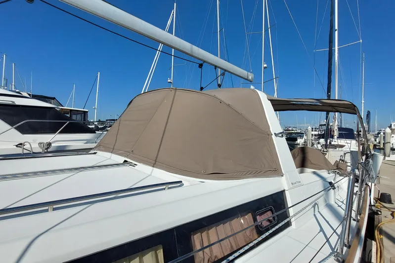 La Bella Vita Yacht Photos Pics 2015 Beneteau Oceanis 45 sailboat docked at marina, featuring beige canopy and sleek design.