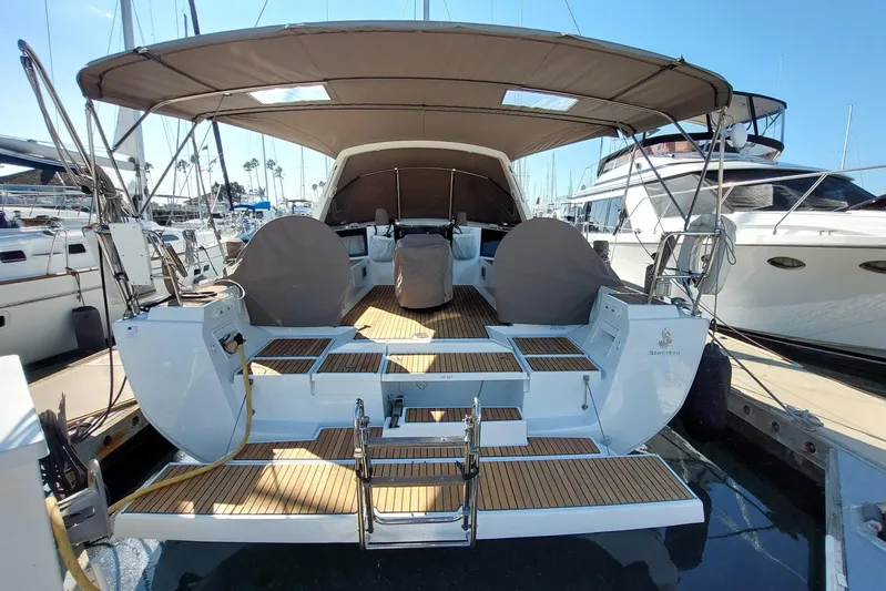 La Bella Vita Yacht Photos Pics 2015 Beneteau Oceanis 45 yacht with spacious deck and canopy in marina.