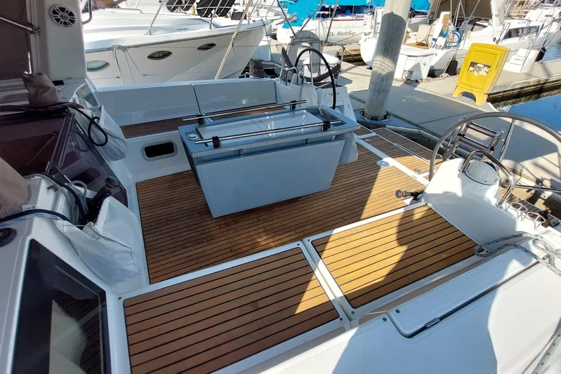 La Bella Vita Yacht Photos Pics Beneteau Oceanis 45 yacht deck, 2015 model, featuring sleek wood finish and dual steering wheels.