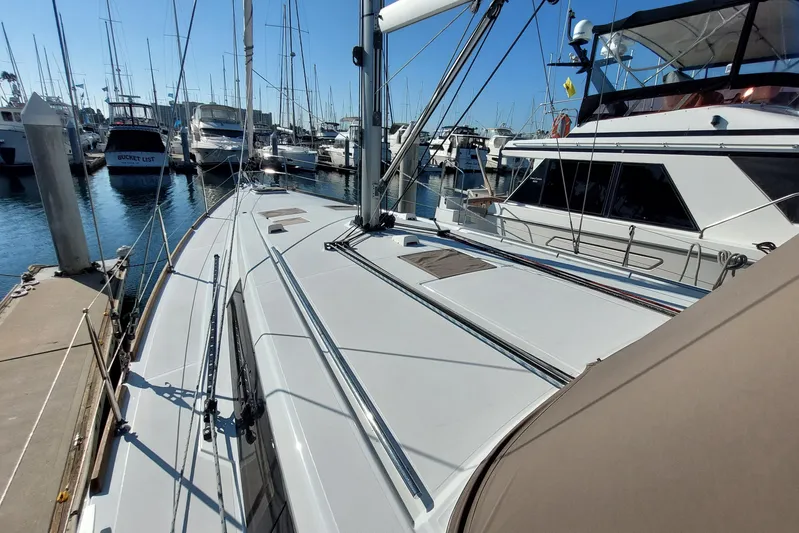 La Bella Vita Yacht Photos Pics 2015 Beneteau Oceanis 45 sailboat docked in a marina, surrounded by other boats.