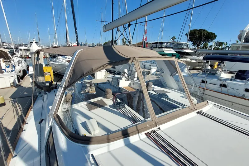 La Bella Vita Yacht Photos Pics 2015 Beneteau Oceanis 45 sailboat docked in marina, featuring spacious deck and canopy.