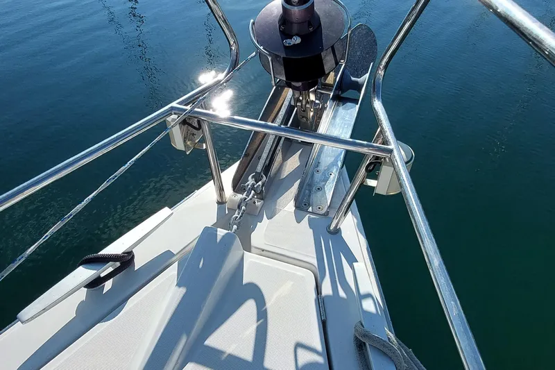 La Bella Vita Yacht Photos Pics Bow of 2015 Beneteau Oceanis 45 sailboat with anchor and railing over calm water.