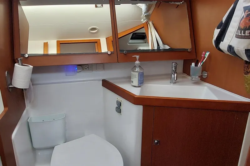 La Bella Vita Yacht Photos Pics Bathroom interior of 2015 Beneteau Oceanis 45 yacht with sink, mirror, and toiletries.
