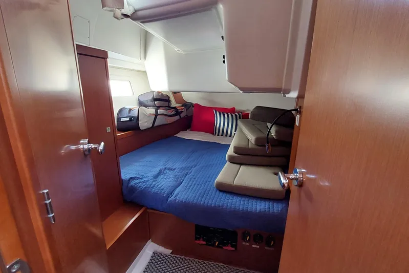 La Bella Vita Yacht Photos Pics Cozy cabin interior of 2015 Beneteau Oceanis 45 yacht with blue bedding and cushions.