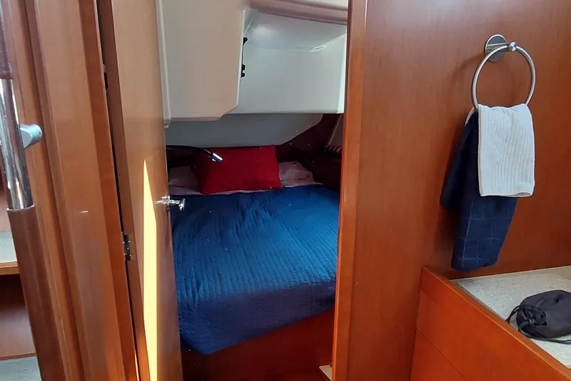 La Bella Vita Yacht Photos Pics Cozy cabin interior of 2015 Beneteau Oceanis 45 sailboat with blue bedding.