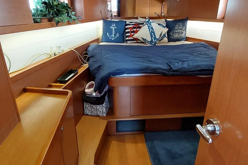 La Bella Vita Yacht Photos Pics Cozy cabin interior of 2015 Beneteau Oceanis 45 with nautical-themed decor.