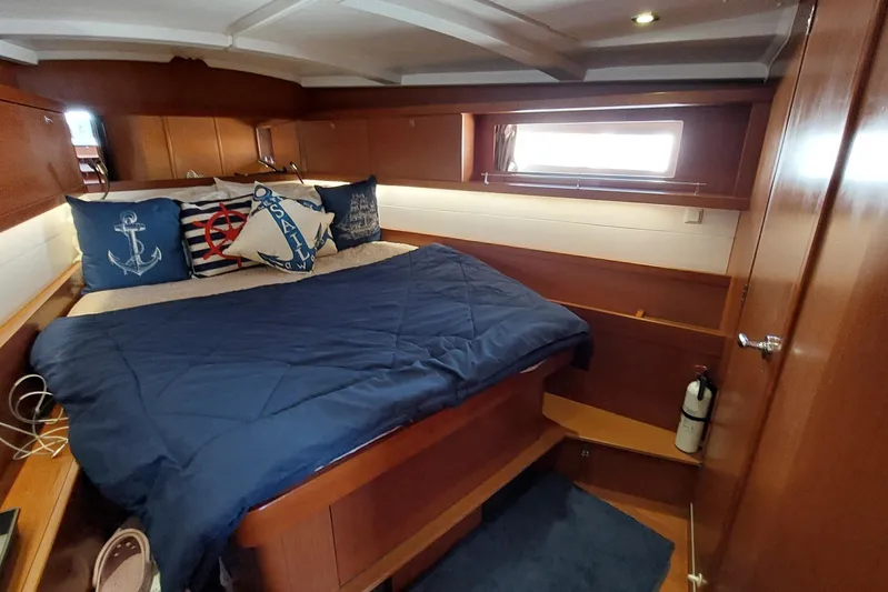 La Bella Vita Yacht Photos Pics Cozy cabin interior of 2015 Beneteau Oceanis 45 with nautical-themed decor.