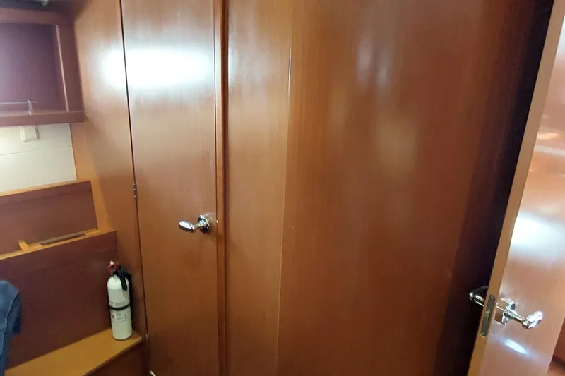 La Bella Vita Yacht Photos Pics Interior of 2015 Beneteau Oceanis 45 yacht with wooden cabinetry and fire extinguisher.
