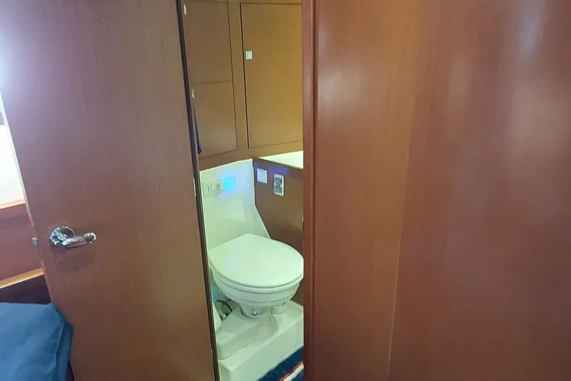 La Bella Vita Yacht Photos Pics Interior view of 2015 Beneteau Oceanis 45 yacht bathroom with wooden finish.