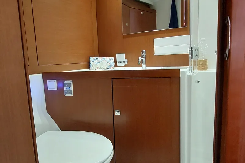 La Bella Vita Yacht Photos Pics 2015 Beneteau Oceanis 45 yacht bathroom with wooden cabinetry and modern fixtures.