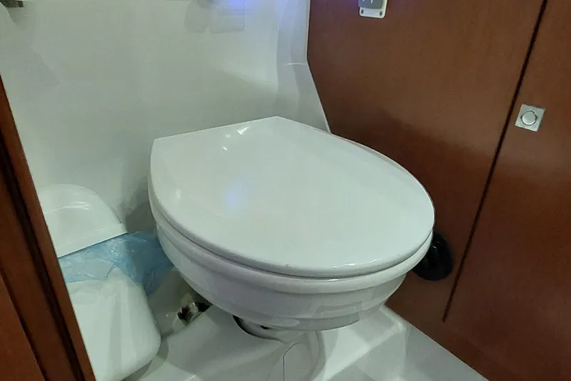 La Bella Vita Yacht Photos Pics Toilet in 2015 Beneteau Oceanis 45 yacht bathroom, featuring wooden cabinetry.