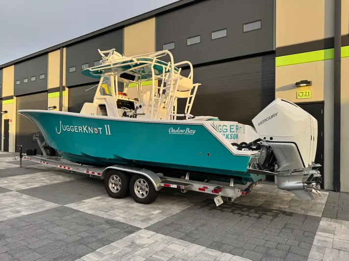  Yacht Photos Pics 2020 Onslow Bay 33 Tournament boat on trailer, parked outside a building.