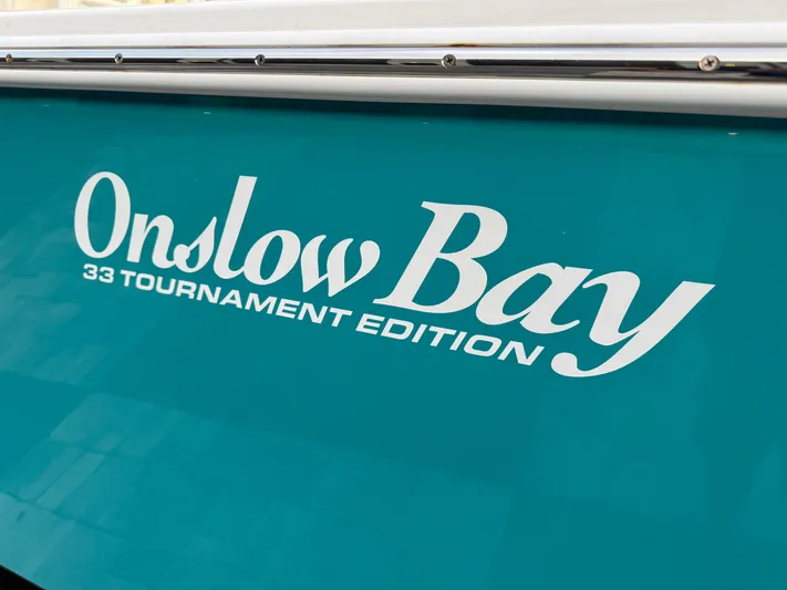 Yacht Photos Pics 2020 Onslow Bay 33 Tournament Edition boat logo on teal background.