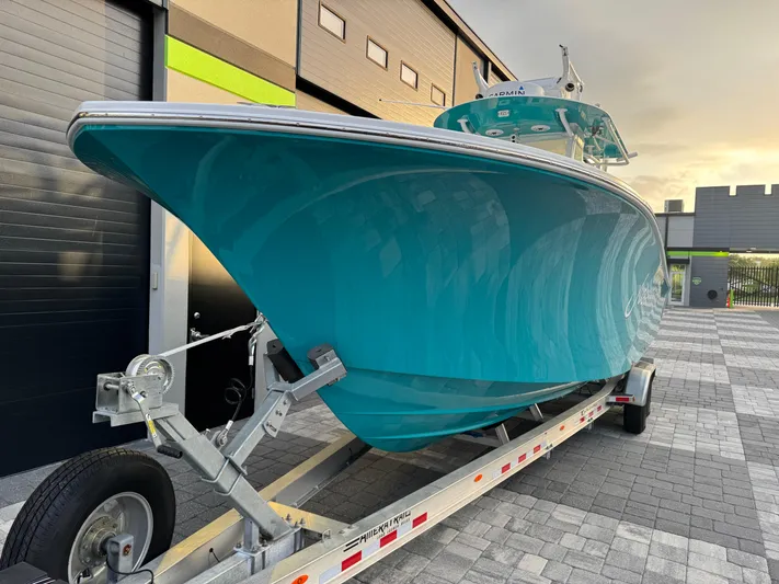  Yacht Photos Pics 2020 Onslow Bay 33 Tournament boat on trailer, teal hull, parked outdoors.