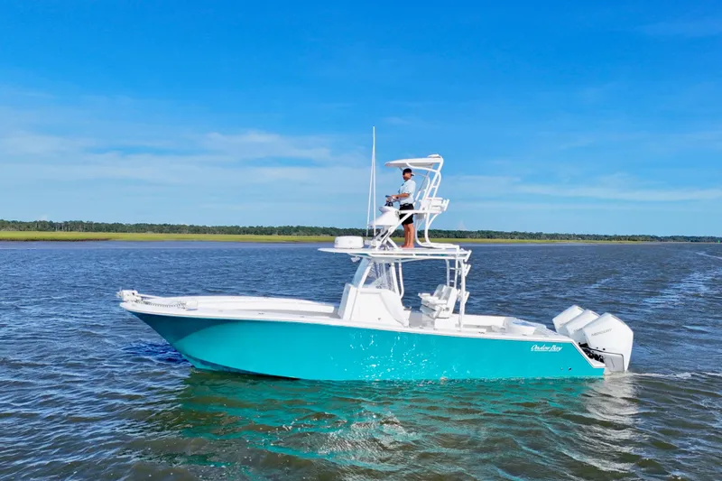  Yacht Photos Pics 2021 Onslow Bay 33 Tournament boat cruising on open water under clear blue sky.