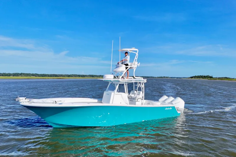  Yacht Photos Pics 2021 Onslow Bay 33 Tournament boat cruising on open water under clear blue sky.