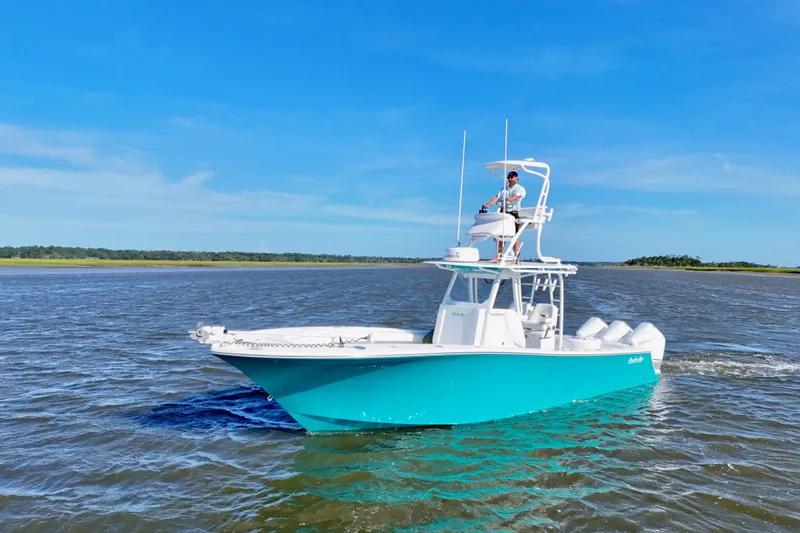 Yacht Photos Pics 2021 Onslow Bay 33 Tournament boat cruising on open water under clear blue sky.