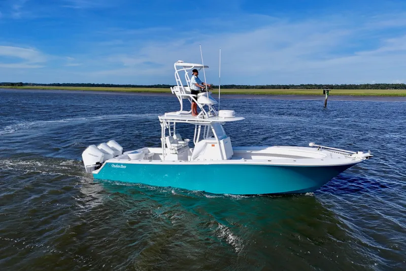  Yacht Photos Pics 2021 Onslow Bay 33 Tournament boat cruising on open water under clear blue skies.