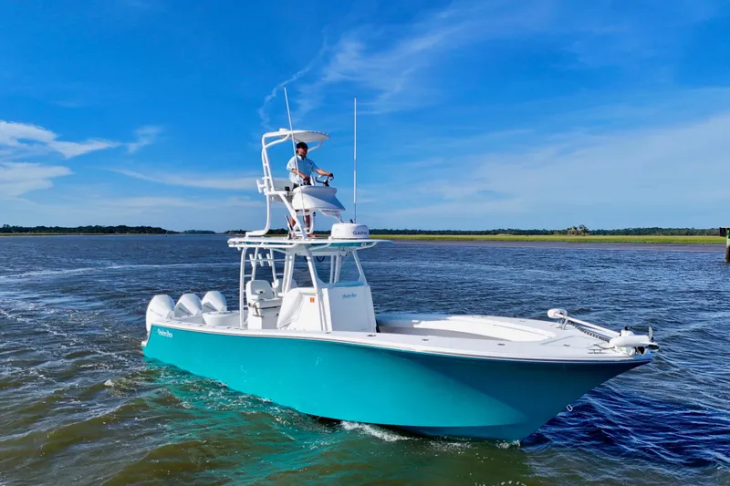  Yacht Photos Pics 2021 Onslow Bay 33 Tournament boat cruising on open water under clear blue sky.