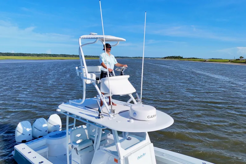  Yacht Photos Pics 2021 Onslow Bay 33 Tournament boat on water, with person steering from upper deck.
