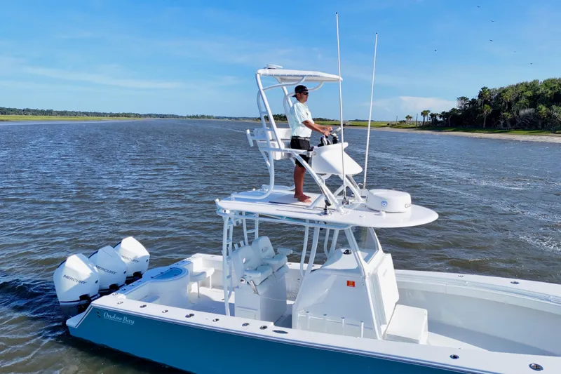  Yacht Photos Pics 2021 Onslow Bay 33 Tournament boat cruising on a scenic waterway.