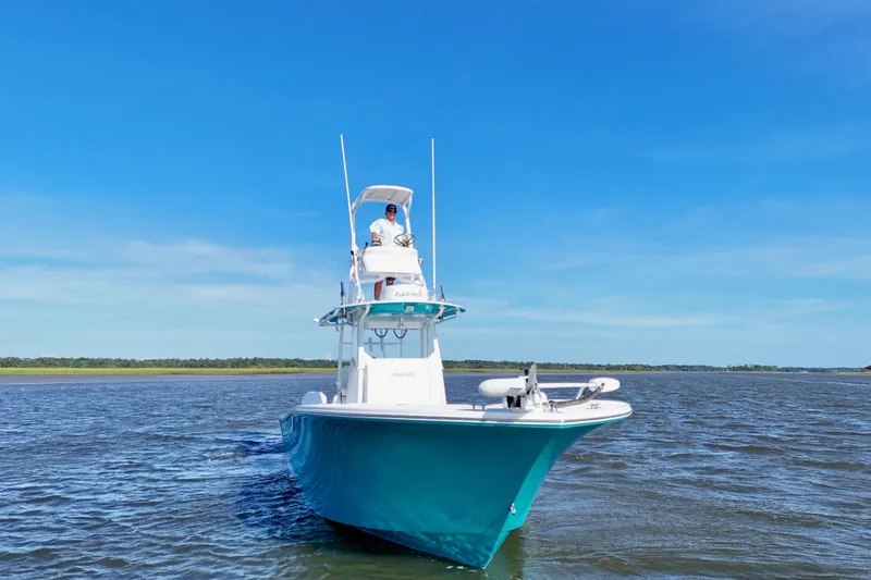  Yacht Photos Pics 2021 Onslow Bay 33 Tournament boat cruising on open water under clear blue sky.