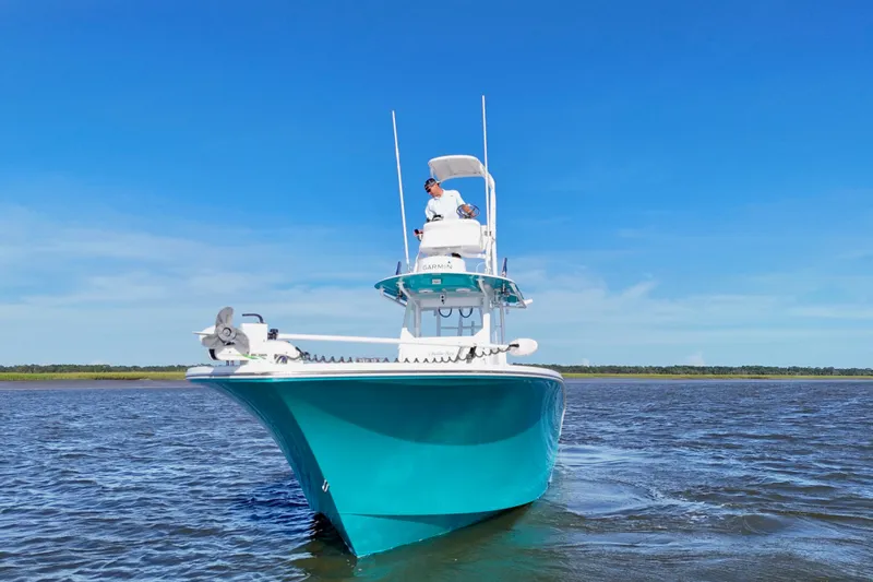  Yacht Photos Pics 2021 Onslow Bay 33 Tournament boat cruising on open water under clear blue sky.