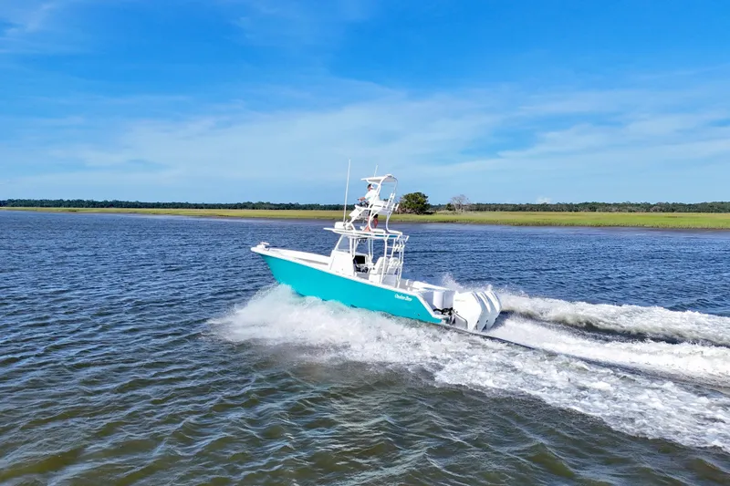 Yacht Photos Pics 2021 Onslow Bay 33 Tournament boat cruising on open water under clear blue sky.