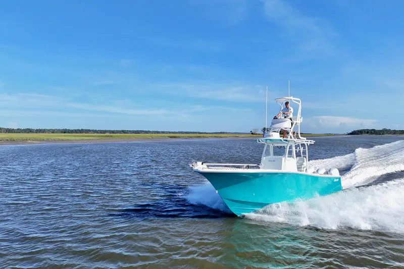  Yacht Photos Pics 2021 Onslow Bay 33 Tournament boat cruising on open water under clear blue sky.