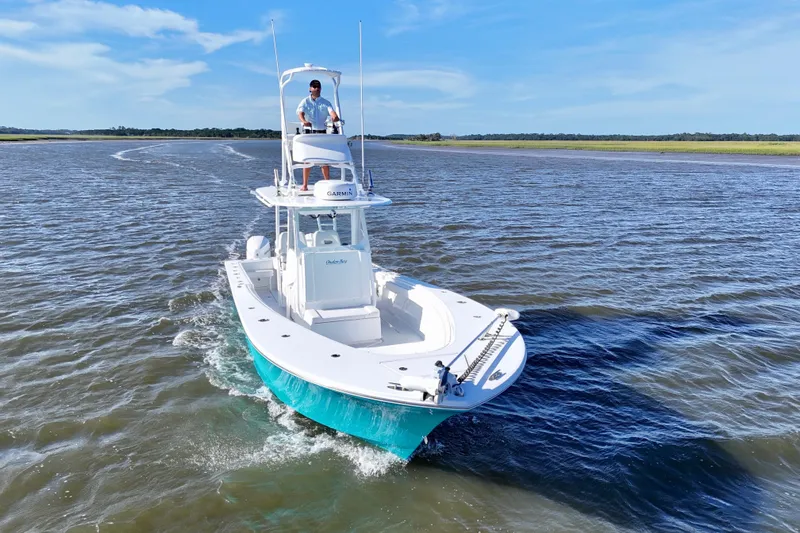  Yacht Photos Pics 2021 Onslow Bay 33 Tournament boat cruising on open water under clear blue skies.