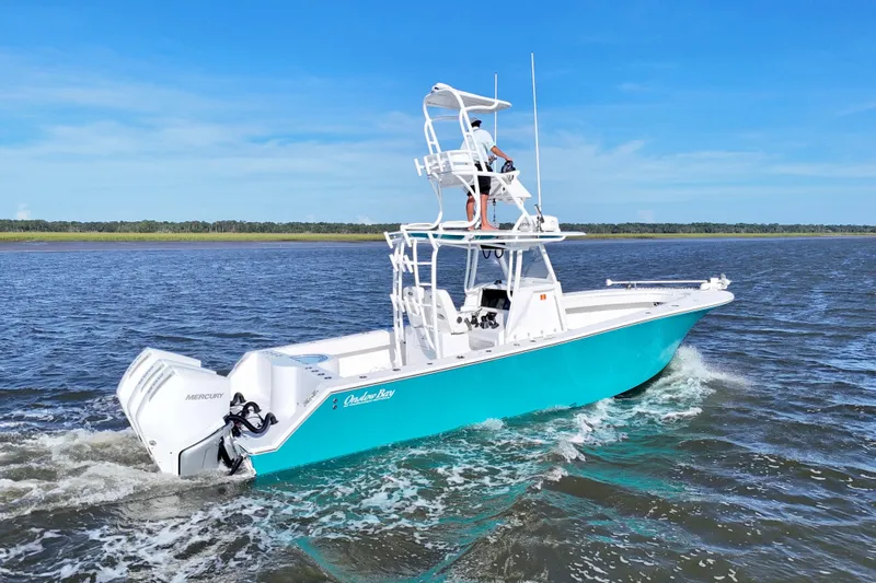  Yacht Photos Pics 2021 Onslow Bay 33 Tournament boat cruising on open water, featuring dual Mercury engines.