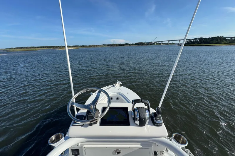  Yacht Photos Pics Onslow Bay 33 Tournament 2021 boat navigating calm waters with bridge in background.