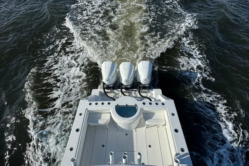  Yacht Photos Pics 2021 Onslow Bay 33 Tournament boat with triple engines cruising on water.