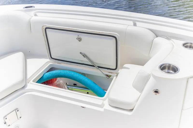  Yacht Photos Pics 2023 Edgewater 262CC boat storage compartment with pool noodle and accessories.