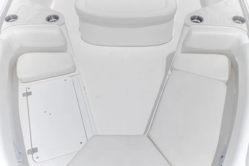  Yacht Photos Pics 2023 Edgewater 262CC boat interior with white cushioned seating and cup holders.