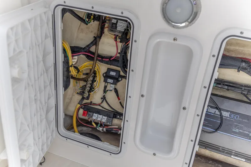  Yacht Photos Pics 2023 Edgewater 262CC boat electrical compartment with wiring and components.