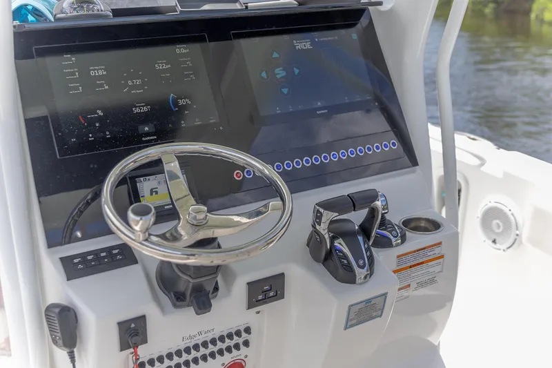  Yacht Photos Pics 2023 Edgewater 262CC boat dashboard with steering wheel and digital controls.