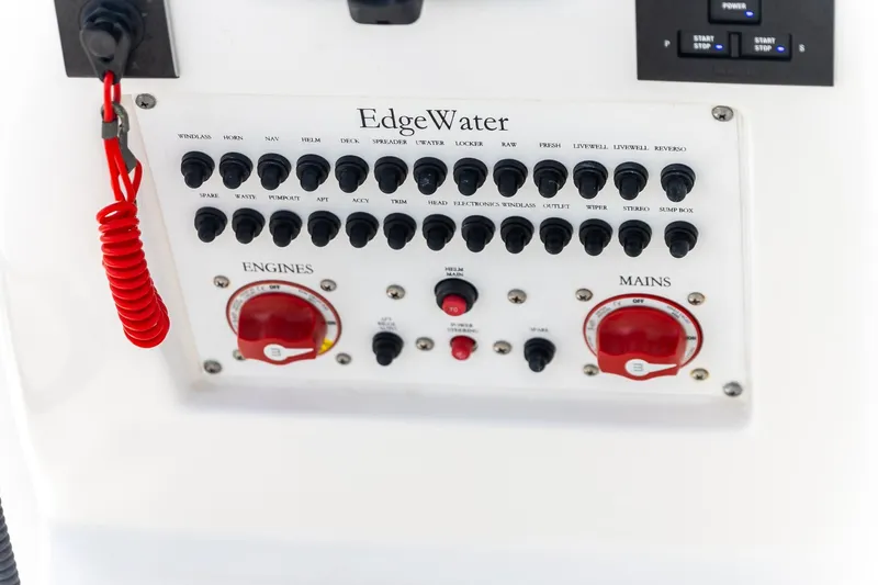  Yacht Photos Pics Control panel of 2023 Edgewater 262CC boat with switches and red safety cord.