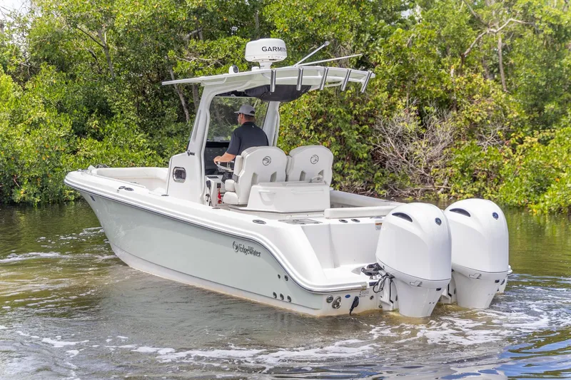  Yacht Photos Pics 2023 Edgewater 262CC boat with dual engines navigating through calm waters.