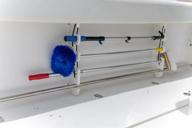  Yacht Photos Pics Storage compartment on 2023 Edgewater 262CC boat with cleaning tools and brushes.