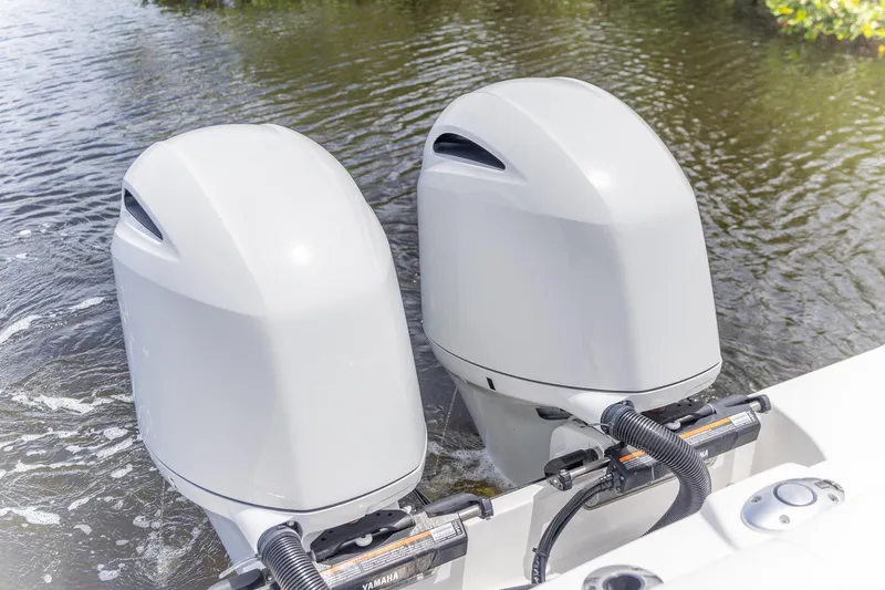  Yacht Photos Pics Twin outboard motors on 2023 Edgewater 262CC boat in water.