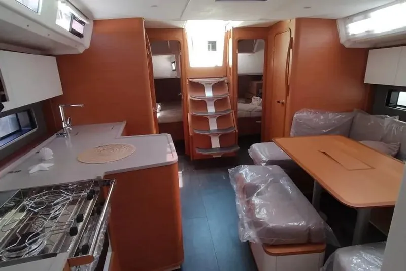  Yacht Photos Pics Interior of 2025 Dufour 41 yacht with modern kitchen and dining area.