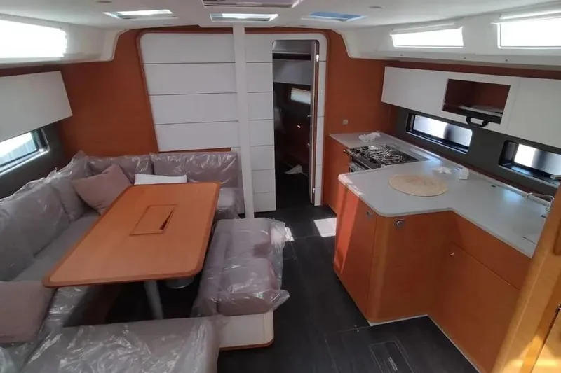  Yacht Photos Pics Interior of 2025 Dufour 41 yacht, featuring modern kitchen and cozy seating area.