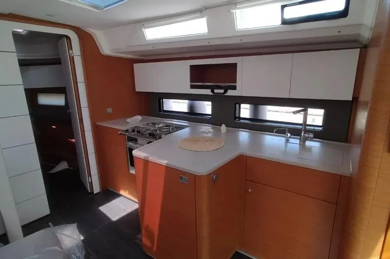  Yacht Photos Pics Modern kitchen interior of 2025 Dufour 41 yacht with sleek cabinetry and appliances.