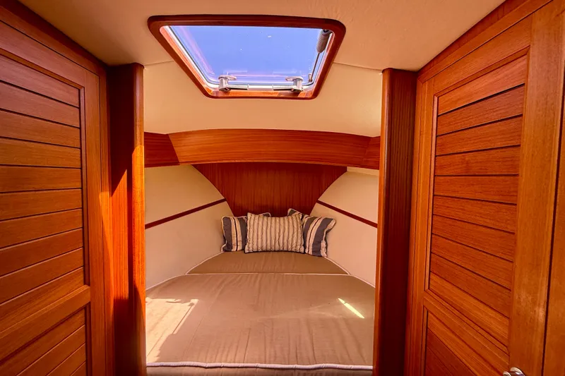 Picnic Yacht Photos Pics Luxurious cabin interior of 2002 Palm Beach Motor Yachts Avalon 38 with skylight and wood finish.