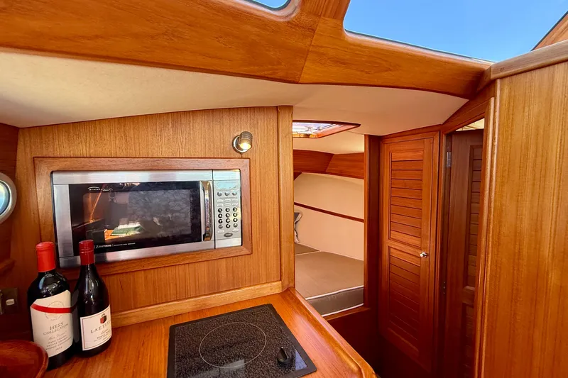 Picnic Yacht Photos Pics Luxurious interior of 2002 Palm Beach Motor Yachts Avalon 38 with wood finish and modern amenities.