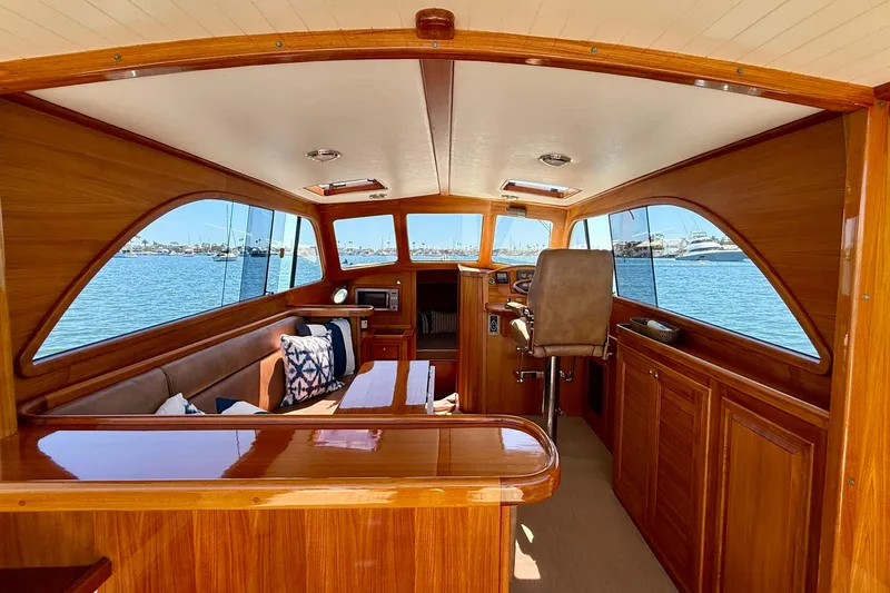 Picnic Yacht Photos Pics Luxurious interior of 2002 Palm Beach Motor Yachts Avalon 38 with wooden finish and waterfront view.