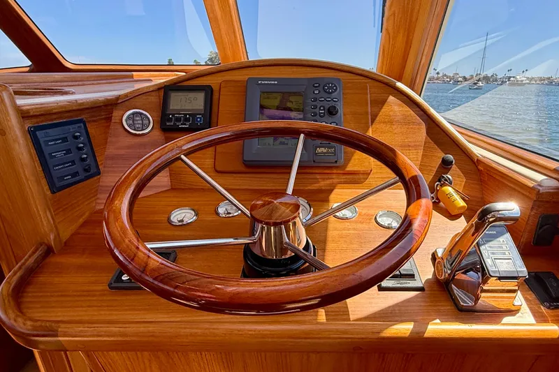 Picnic Yacht Photos Pics Steering wheel and controls of 2002 Palm Beach Motor Yachts Avalon 38, with navigation instruments.